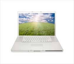 Silver computer laptop with arched horizon of grass field and sky isolated on a white background