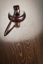 Dark wooden gavel abstract on reflective table with room for text