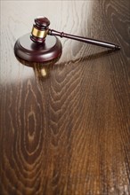 Dark wooden gavel abstract on reflective table with room for text