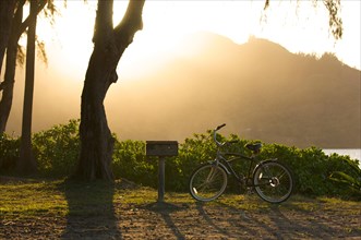 Sunset on hanalei bay with backlit bike and BBQ