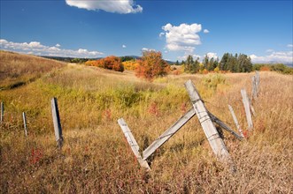 Beautiful fall landscape with rustic fence and clouds