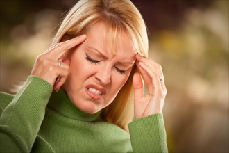 Grimacing woman suffering a painful headache