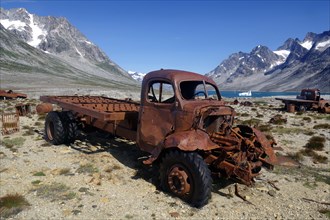 Old transport in front of rough mountains