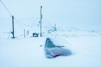 Snowed-in car in winter