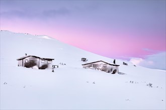 Cabins in winter landscape