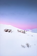 Cabins in winter landscape