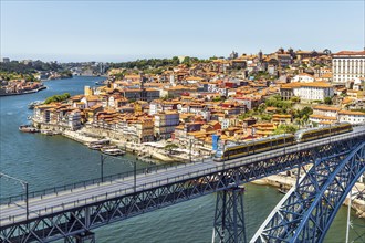 Beautiful panorama of city of Porto with metro on famous bridge