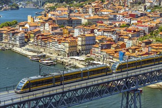 Beautiful panorama of city of Porto with metro on famous bridge