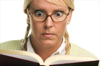 Stunned female with ponytails and book isolated on a white background
