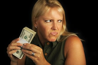 Attractive woman gets greedy about her stack of money