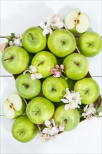 Apples fruits green apple fruit box on wooden board with flowers and leaves
