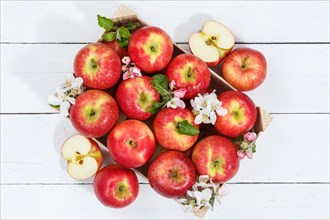 Apples fruits red apple fruit box on wooden board with flowers and leaves
