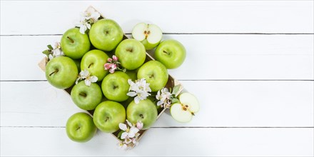 Apples fruits green apple fruit box on wooden board banner text free space copyspace with flowers and leaves