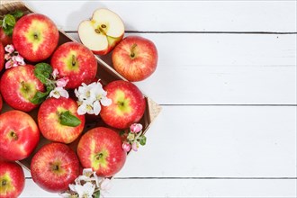 Apples fruits red apple fruit box on wooden board text free space copyspace with flowers and leaves
