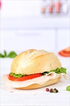 Roll sandwich baguette topped with ham text free space copyspace on wooden board in germany