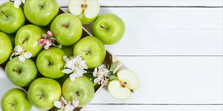 Apples fruits green apple fruit box on wooden board banner text free space copyspace with flowers and leaves