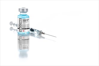 Coronavirus COVID-19 vaccine vial and syringe on reflective white background