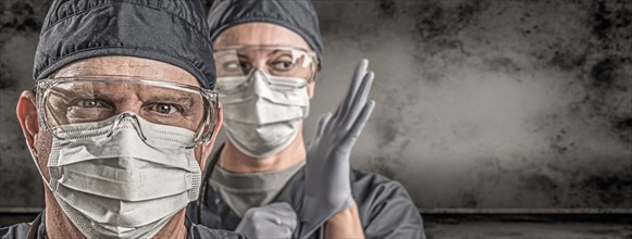 Female and male doctors or nurses wearing scrubs and protective mask and goggles banner