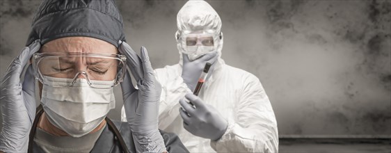 Female and male doctors or nurses wearing scrubs and protective mask and goggles banner