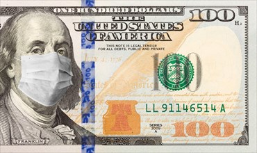 One hundred dollar bill with medical face mask on benjamin franklin