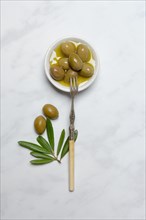 Olives in small bowl with fork