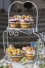 Vintage etagere with cupcakes on a candy bar