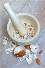 Broken eggshells crushed with mortar