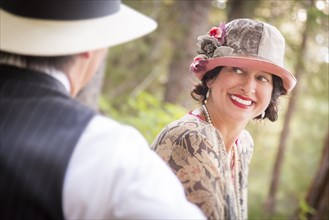 Attractive 1920s dressed romantic couple flirting outdoors
