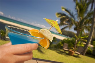 Woman with tropical drinks on Lanai