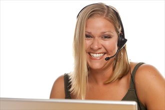 Beautiful friendly female customer support phone operator in front of a computer screen isolated on a white background