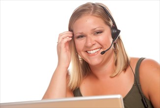 Attractive businesswoman smiles as she talks on her phone headset