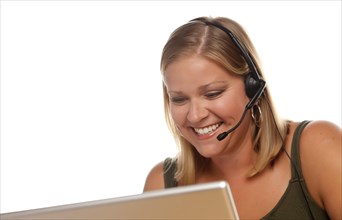 Beautiful friendly female customer support phone operator in front of a computer screen isolated on a white background