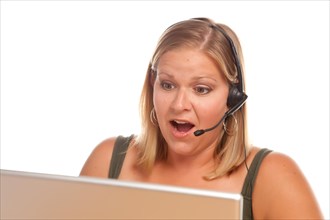 Shocked businesswoman talks on her phone headset using computer