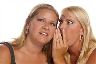 Two blonde woman whispering secrets isolated on a white background