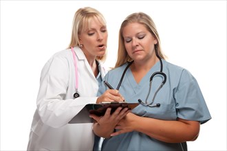 Two doctors or nurses looking over file on clipboard isolated on a white background