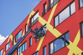 Colorful facade with window cleaners