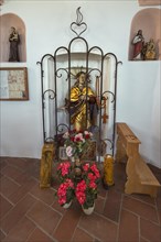 Figure of a saint with floral decoration