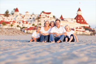 Happy caucasian family in front of hotel del coronado on a sunny afternoon