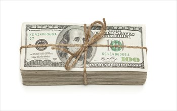 Stack of one hundred dollar bills tied in a burlap string isolated on a white background