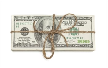 Stack of one hundred dollar bills tied in a burlap string isolated on a white background