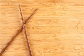 Bamboo textured surface background with chop sticks and plenty of room for text