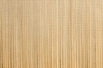 Uniform tan bamboo mat background overhead image