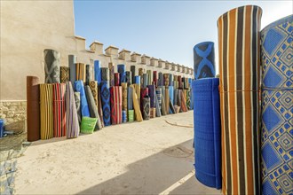 Many rolls of plastic carpet sold on Northafrican open air market in Agadir
