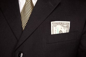 United stated dollar bill in businessman's coat pocket