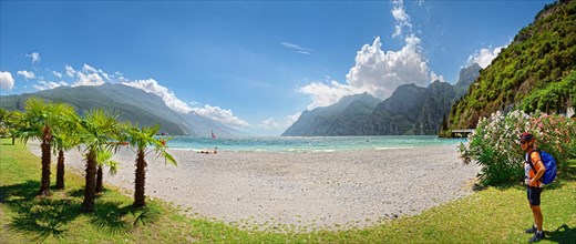 Lake Garda north shore with palm trees and cycling