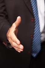 Businessman reaching his hand out for a handshake