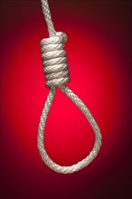 Hangman's noose over red spot lit background