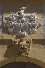 Alliance coat of arms of Johann Melchior Hirschfelder and his woman above the main entrance of a baroque facade from 1710