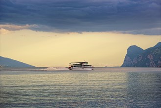 Lake Garda north shore with passenger ferry at sunset