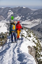 Young woman and man on ski tour